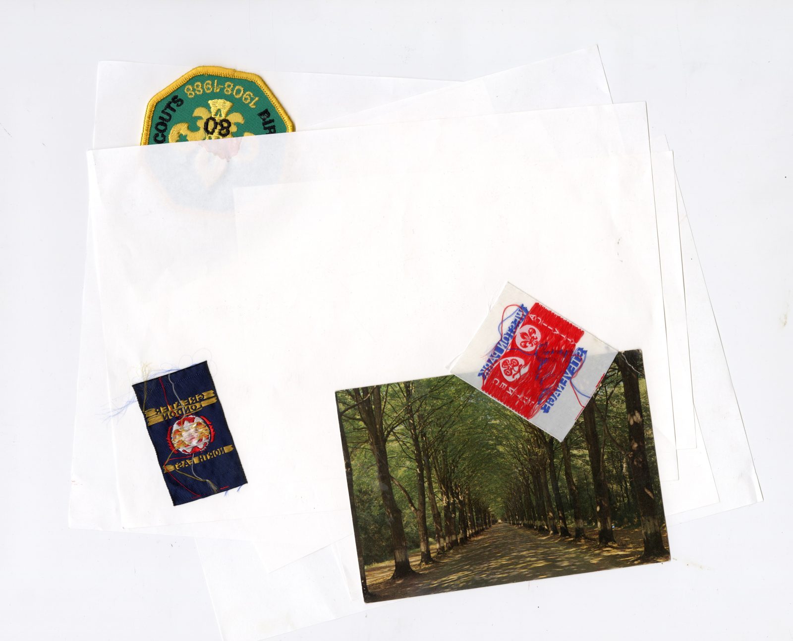 Blank bible paper, scout badges, found postcard